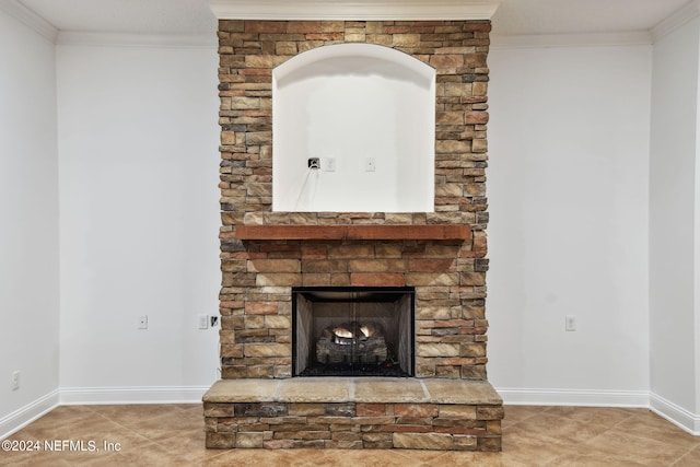 details featuring a stone fireplace and crown molding