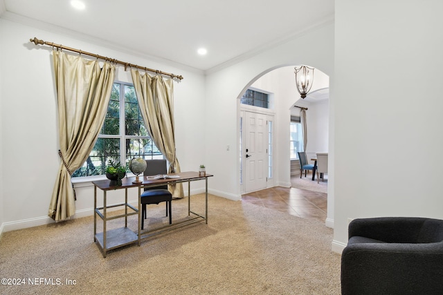 carpeted home office featuring crown molding