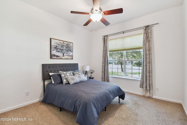 bedroom with ceiling fan and light carpet