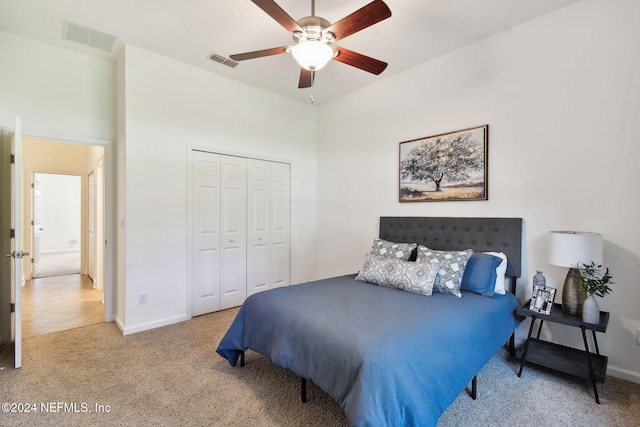 carpeted bedroom with a closet and ceiling fan