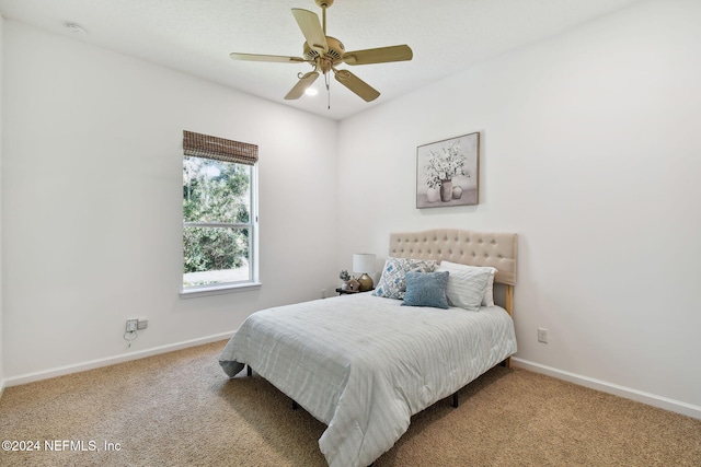 bedroom featuring light colored carpet and ceiling fan