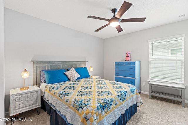 carpeted bedroom with ceiling fan and multiple windows