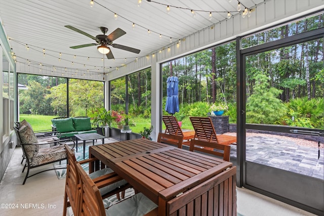 sunroom / solarium featuring ceiling fan