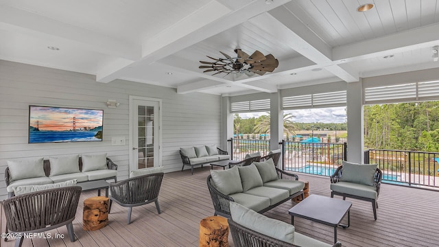 wooden terrace with ceiling fan, an outdoor living space, and a fenced in pool