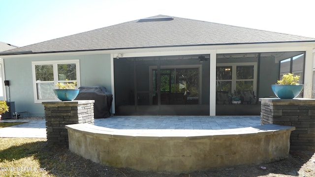 back of property with a sunroom