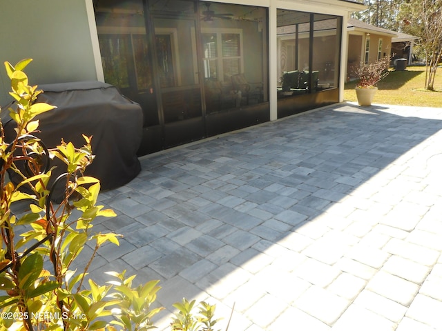 view of patio / terrace featuring a grill and a sunroom