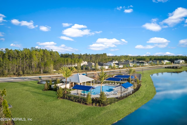 view of pool featuring a water view and a yard