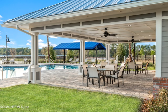 view of patio featuring a fenced in pool and ceiling fan