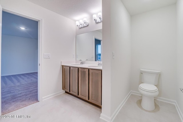 bathroom featuring vanity, toilet, and tile patterned flooring