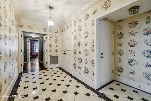 foyer entrance with ornamental molding and hardwood / wood-style flooring