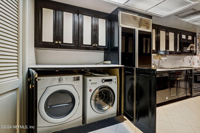 laundry room with separate washer and dryer, cabinets, sink, and light tile patterned flooring