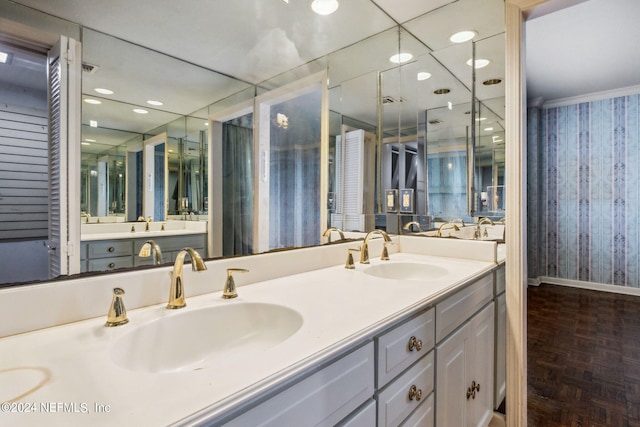 bathroom featuring parquet floors and vanity