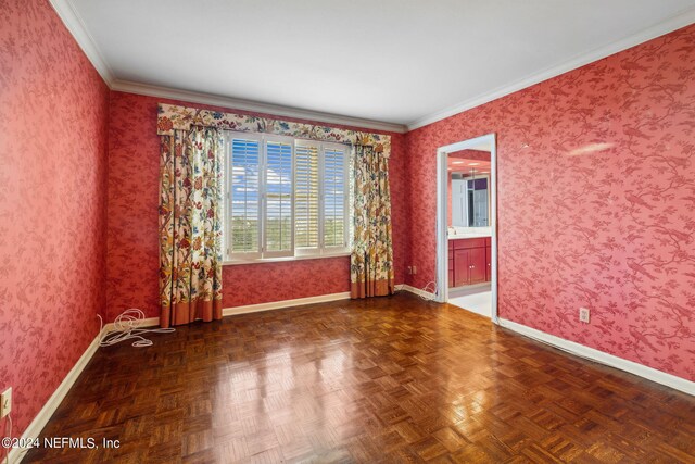 empty room featuring crown molding and dark parquet floors