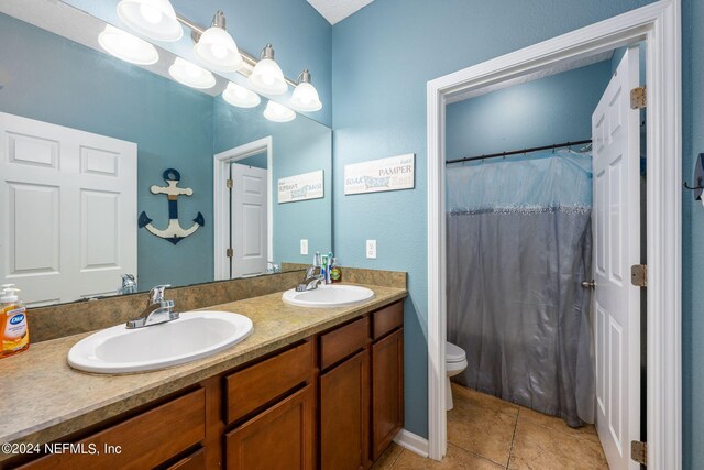 bathroom featuring tile patterned flooring, vanity, toilet, and a shower with curtain