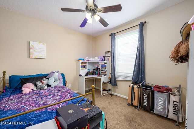 carpeted bedroom with a textured ceiling and ceiling fan