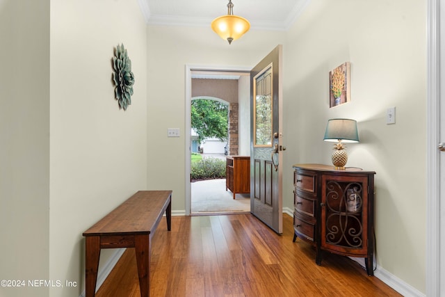 entrance foyer featuring hardwood / wood-style flooring and crown molding