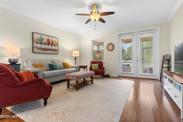 living room featuring hardwood / wood-style floors, ceiling fan, crown molding, and french doors