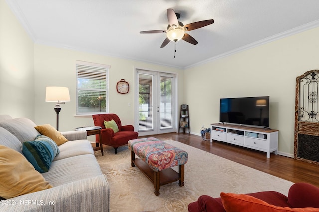 living room with ceiling fan, dark hardwood / wood-style flooring, crown molding, and french doors