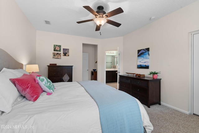 carpeted bedroom featuring ensuite bathroom and ceiling fan