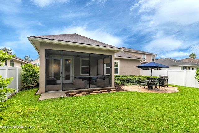 back of property featuring a patio area, a sunroom, a yard, and outdoor lounge area