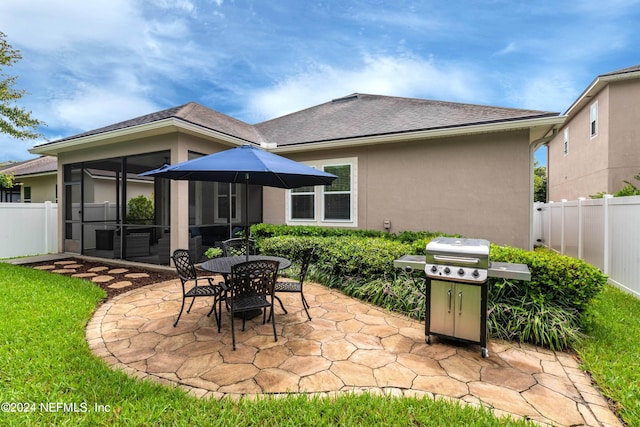 rear view of house with a patio area and a sunroom