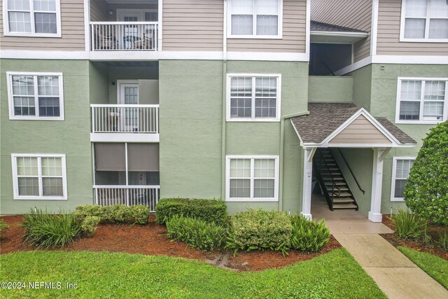 view of exterior entry featuring a balcony