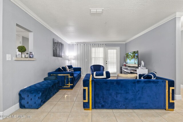 tiled living room with ornamental molding and a textured ceiling