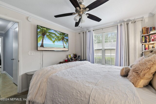 bedroom with ceiling fan and ornamental molding