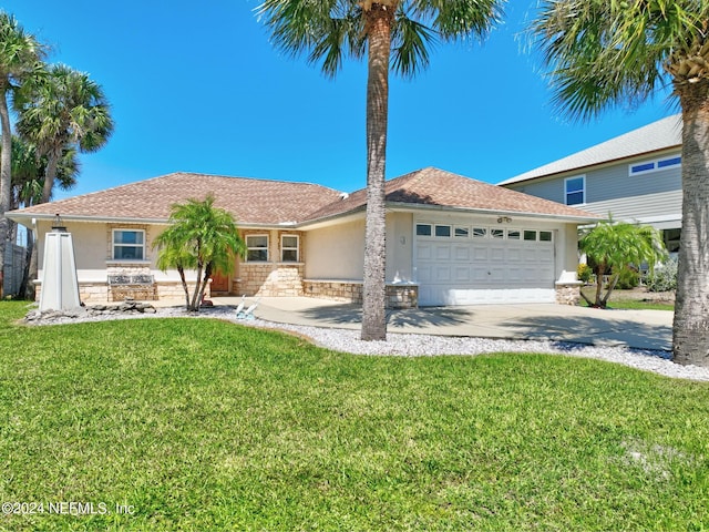 view of front of house with a front yard and a garage