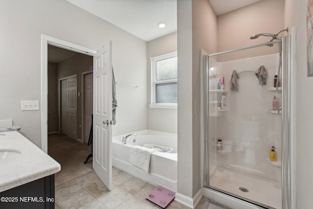 bathroom with tile patterned flooring, vanity, and plus walk in shower