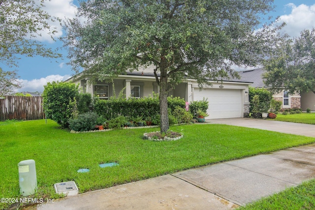 view of front of property with a garage and a front lawn