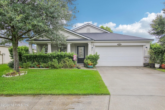 view of front of home featuring a garage and a front lawn