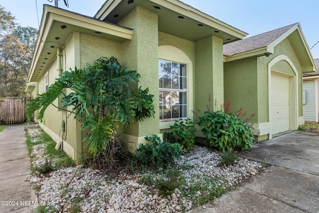 view of side of home featuring a garage