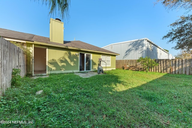 rear view of property featuring a yard