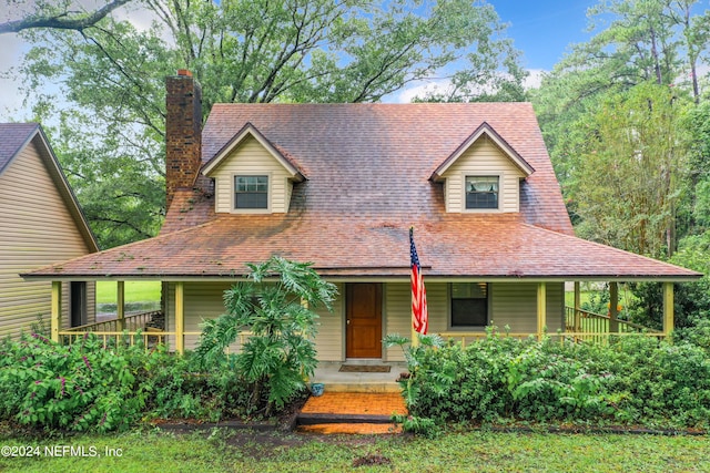 35061 Karen Rd, Callahan, FL 32011 - farmhouse featuring a chimney, a porch, and roof with shingles