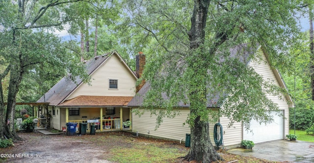 35061 Karen Rd, Callahan, FL 32011 - view of front facade with a garage and a chimney
