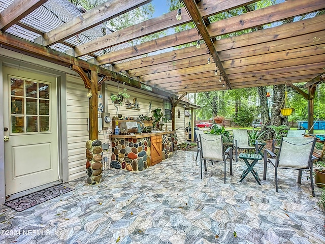 view of patio / terrace featuring an outdoor kitchen and a pergola