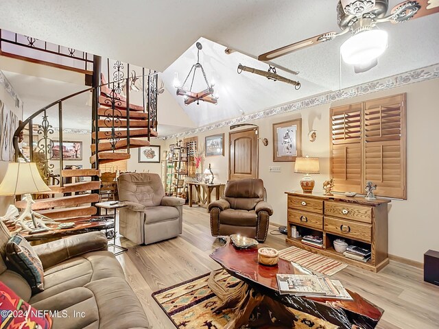 35061 Karen Rd, Callahan, FL 32011 - living area with stairs, a notable chandelier, wood finished floors, a textured ceiling, and baseboards