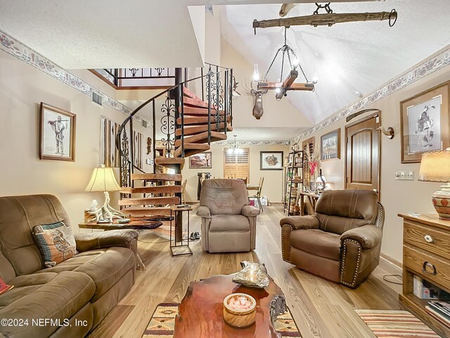 35061 Karen Rd, Callahan, FL 32011 - living area featuring vaulted ceiling, stairway, a chandelier, and wood finished floors