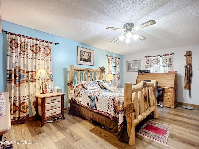 bedroom with ceiling fan, a textured ceiling, and light hardwood / wood-style flooring