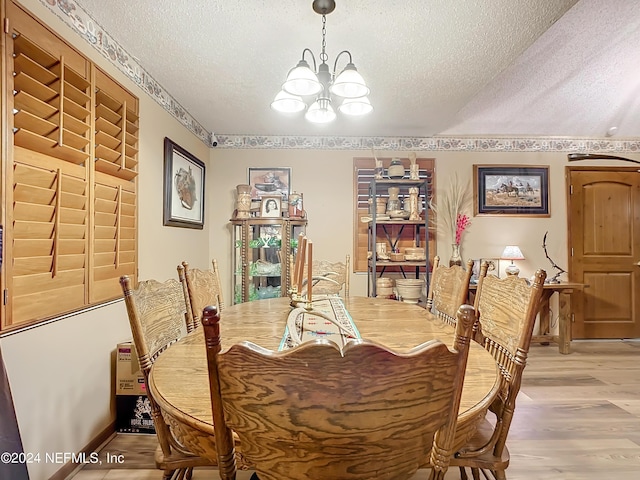 35061 Karen Rd, Callahan, FL 32011 - dining room with a textured ceiling, a chandelier, and light wood finished floors