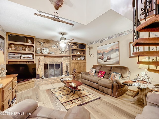 living room featuring wood-type flooring, built in features, and ceiling fan