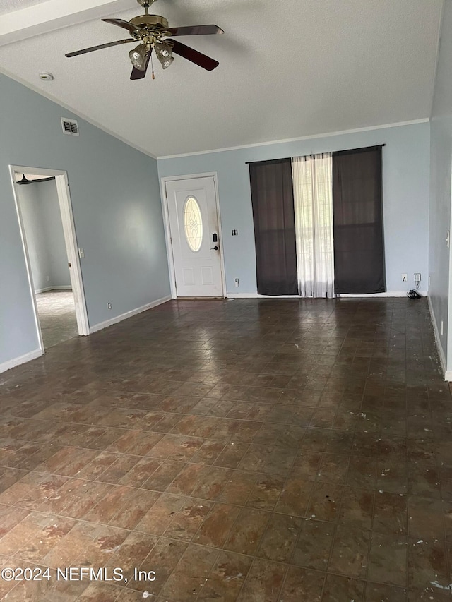 foyer featuring a textured ceiling, lofted ceiling, and ceiling fan