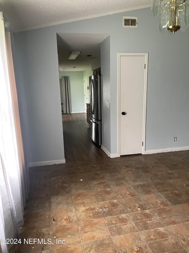 hall with a textured ceiling