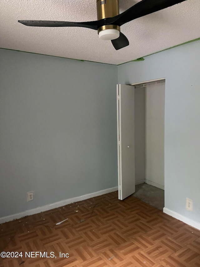 unfurnished room featuring a textured ceiling and parquet floors