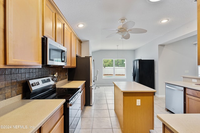 kitchen with ceiling fan, light tile patterned flooring, tasteful backsplash, stainless steel appliances, and a center island