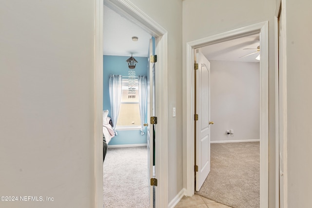 corridor featuring light colored carpet