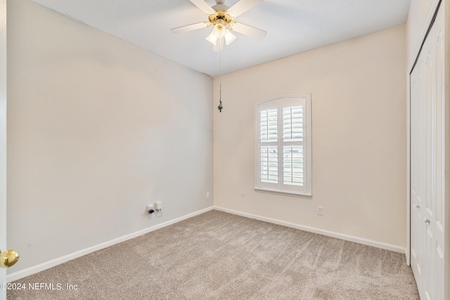 unfurnished bedroom with ceiling fan, light colored carpet, and a closet