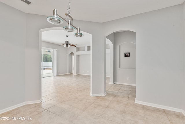 empty room featuring ceiling fan and light tile patterned floors