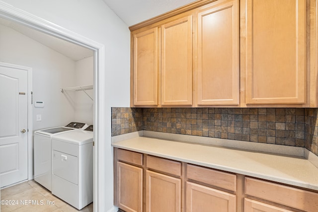 clothes washing area featuring separate washer and dryer and light tile patterned flooring